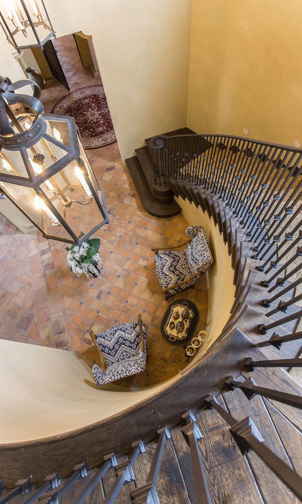 A wrought iron stair railing in Tuscan style architecture.