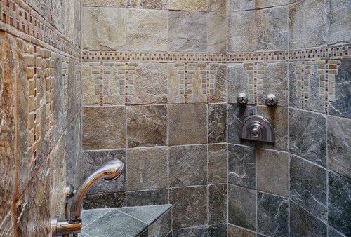 Wisteria tilework adorns the shower in this custom designed home 