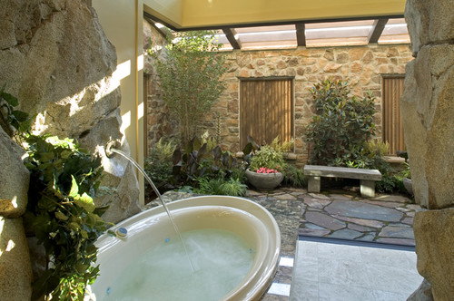 Hillcrest Farm takes destination bathtubs to new heights with a grotto-style tub overlooking an indoor garden.