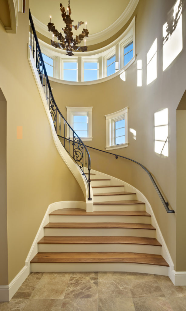 Lakeside Lookout uses artful interior architecture, like this turret staircase, to create a Mediterranean aesthetic.