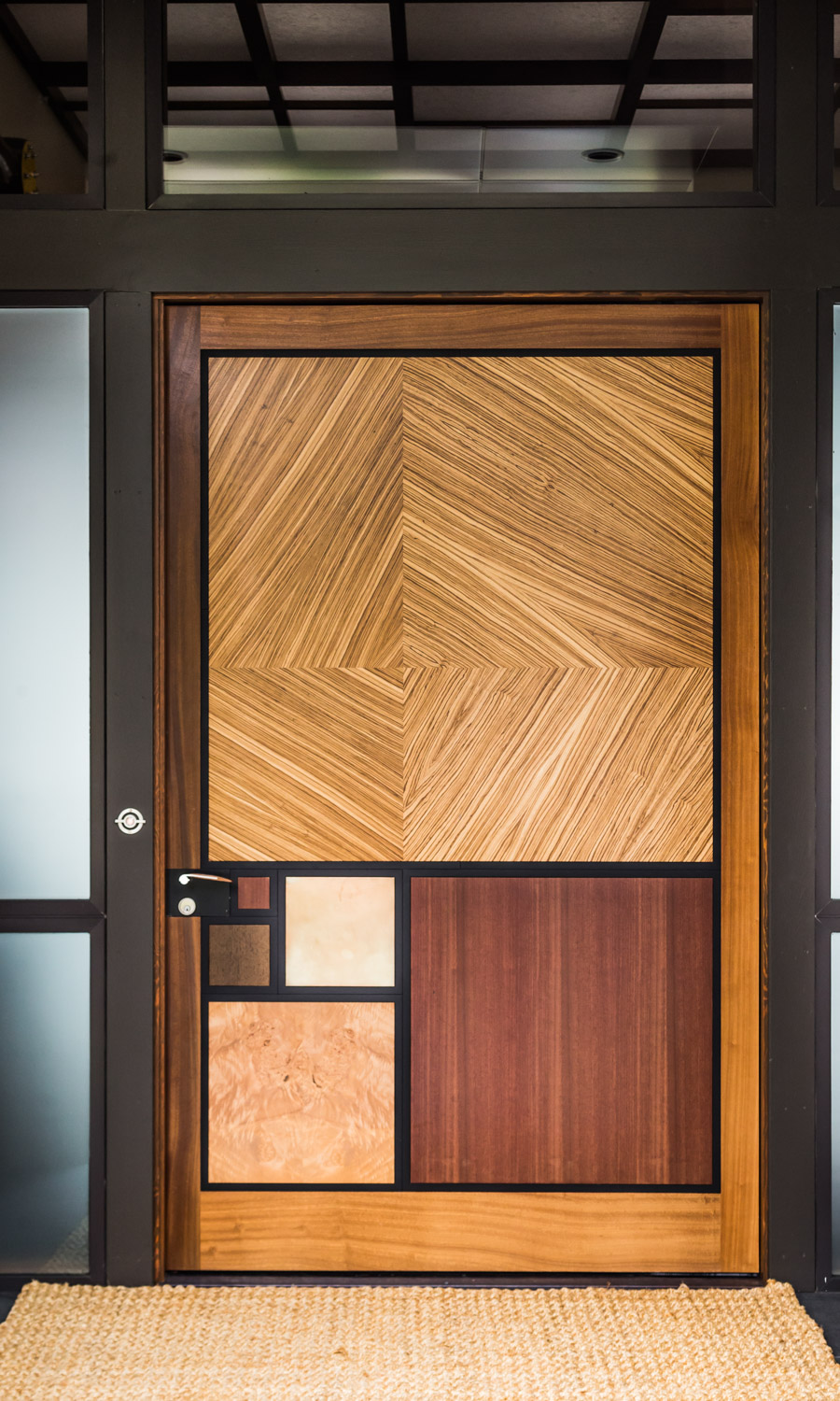The front door at Ratio House embraces the art of architectural details through rich texture and golden rectangles.