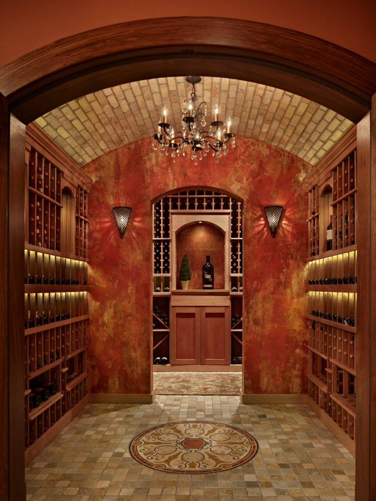 An arched doorway in a home wine cellar