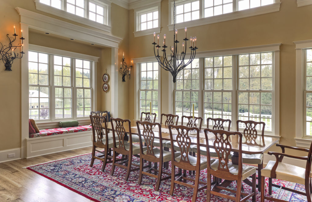 Traditional farmhouse architecture inspires this spacious formal dining room designed for an equestrian lifestyle.